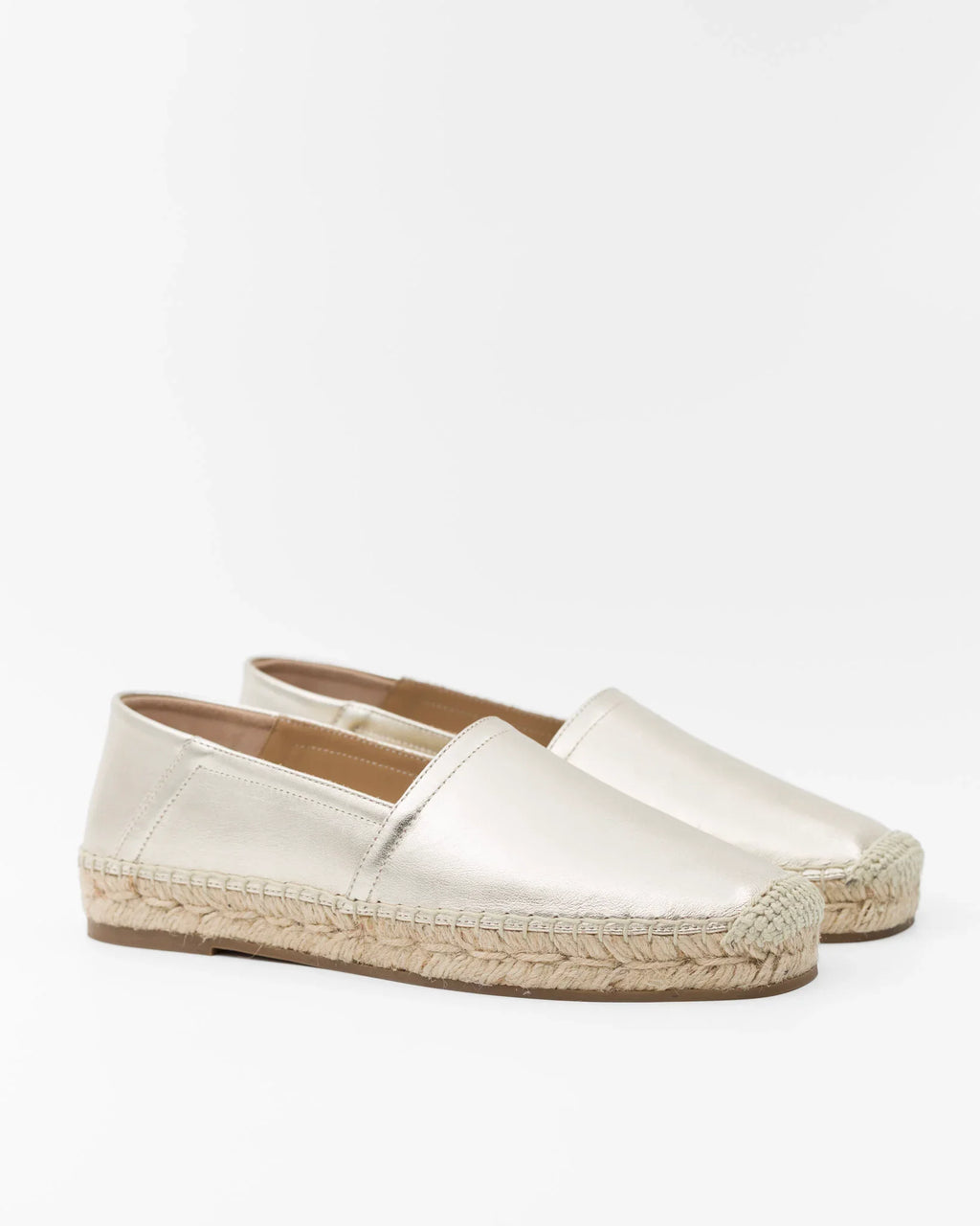Elegant white espadrilles with woven jute soles, perfect for summer fashion.